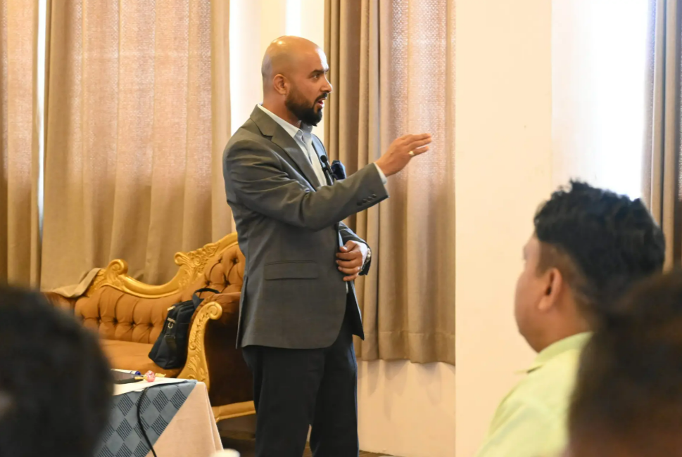 Diwakar Rijal speaking to a business team about employee performance in Nepal